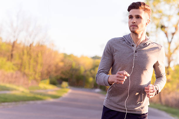 istock Cheerful young jogger running in park 544324002