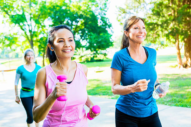 istock Senior female friends exercise together in park 544325982