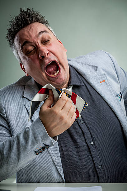 istock businessman sneezing on his necktie 544326098