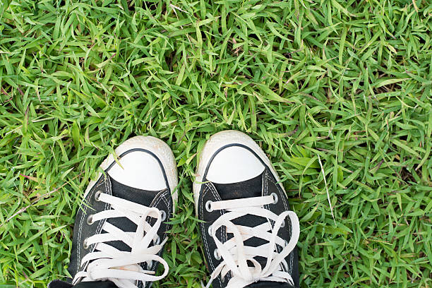 istock black sneakers on green grass 544326612
