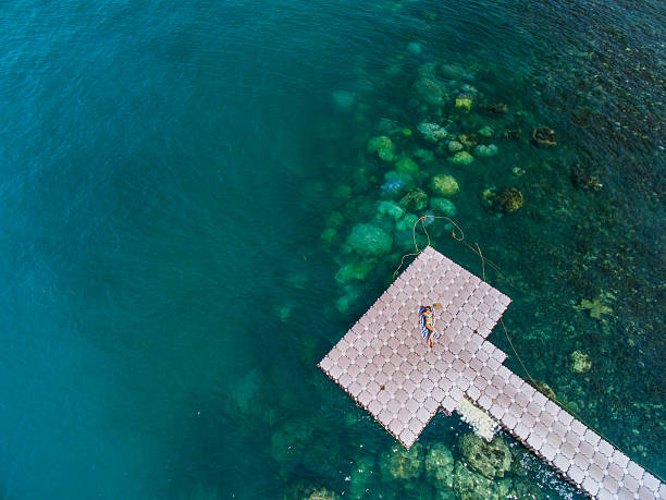 istock Woman on pontoon bridge aerial view 544327374