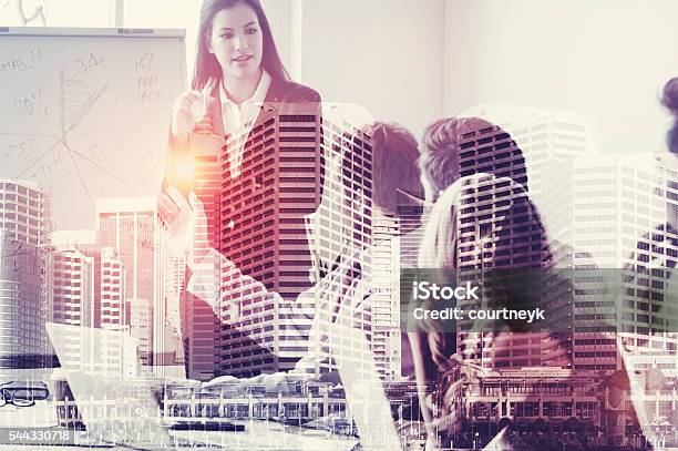 Group Of Business People In A Presentation Stock Photo - Download Image Now - Multiple Exposure, Cooperation, Suit