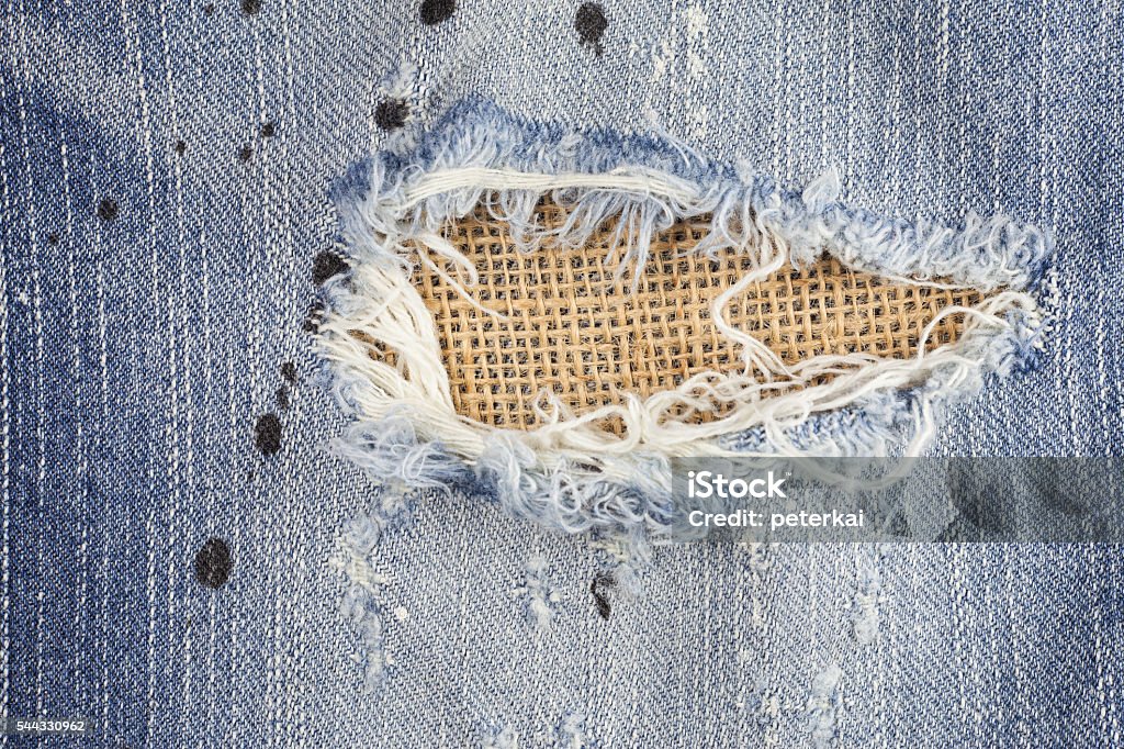 Torn jeans, Old jeans. Torn jeans, Old jeans, Torn denim jeans texture, Torn blue jean fabric texture, Jeans background, Texture of blue jeans Abstract Stock Photo