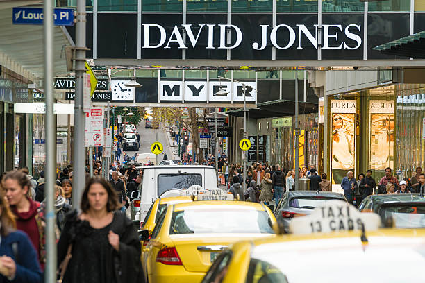 People walking along a busy street in Melbourne Melbourne, Australia - Jul 2, 2016: People walking along Little Bourke street in downtown Melbourne, Australia. It is a popular shopping area with major department stores such as Myer and David Jones. melbourne street crowd stock pictures, royalty-free photos & images