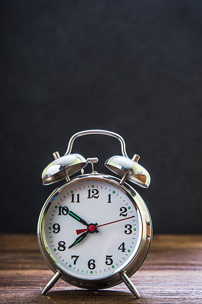 istock retro alarm clock with black notice board 544332440