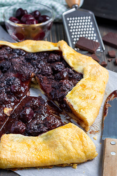 istock Cottage cheese dough galette with cherries and chocolate, vertical 544332730
