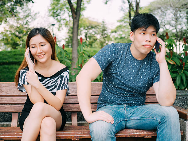 istock Asian couple talking on the phone with different emotions 544332984