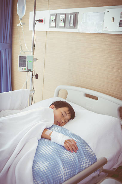 istock Asian boy lying on sickbed with saline intravenous (IV). Health 544334846