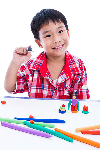 istock Asian kid playing with play clay. Strengthen the imagination. 544335436
