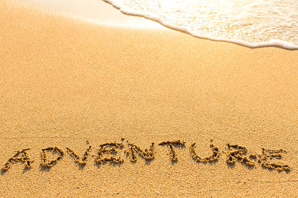 istock Adventure - word drawn on the sand beach 544335570