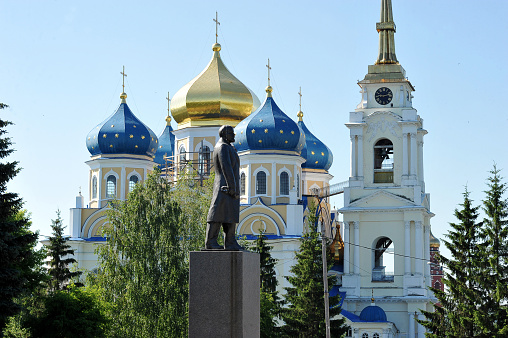 monument to Lenin in the background of the Orthodox Church in the city of Bolkhov, Russia