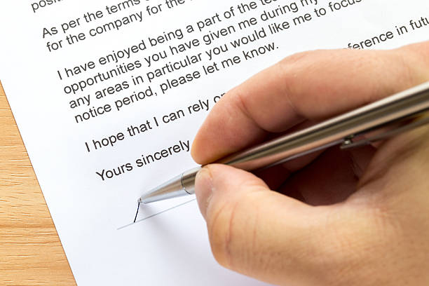 istock Hand signing resignation letter 544339562