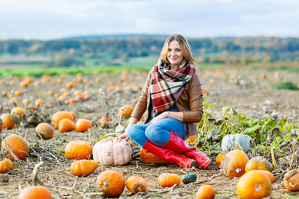 istock Beautiful woman working on pumpkin field 544340050