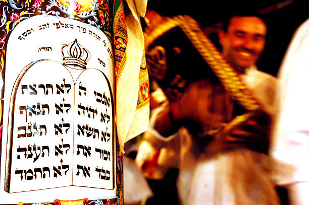 Celebrating Jewish Holiday Simchat Torah in a Synagogue Sderot, Israel - October 14, 2006: Orthodox Jewish Men celebrate Simchat Torah by dancing with the scrolls of the Torah at a Synagogue on October 14 2006 in Sderot, Israel. Simchat Torah is a celebratory Jewish holiday that marks the completion of the annual Torah reading cycle. simchat torah photos stock pictures, royalty-free photos & images