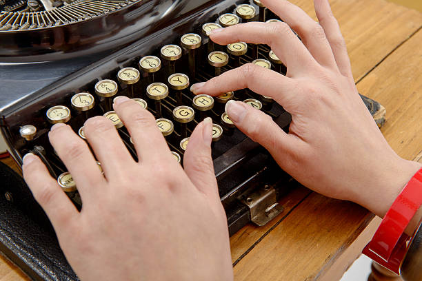 istock hands of a young woman with an old typewriter 544340840