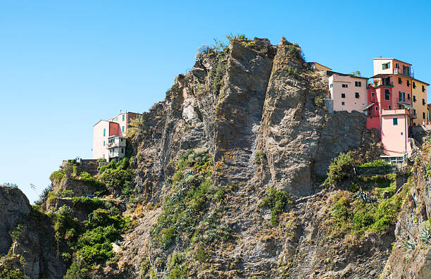 Manarola, Italy - September 8, 2015: View from the sea of the village climbing on the mountain  rocky ridges.