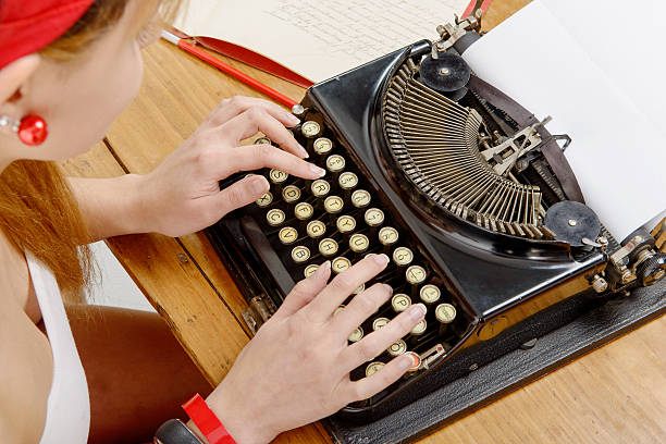 istock hands of a young woman with an old typewriter 544341150