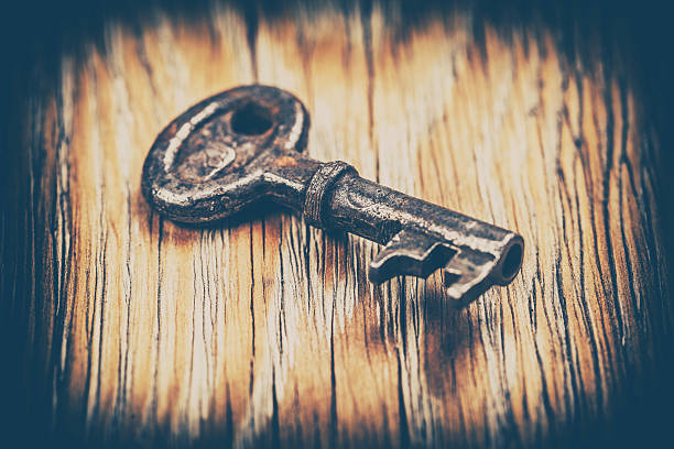 istock old key on a brown wooden background 544344992
