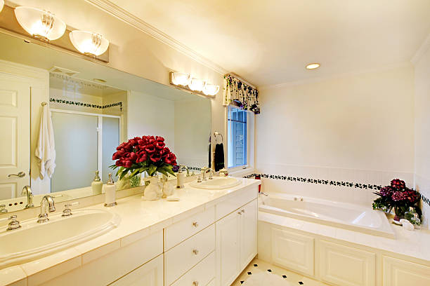 istock Elegant white bathroom interior decorated with flowers. 544346576