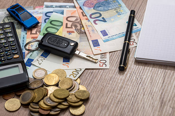 istock car key, euro banknotes, pen, coins and notebook 544346840