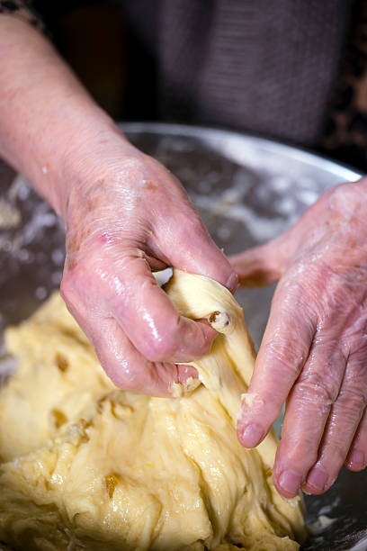 istock Wrinkled hands elderly hostess knead the pastry 544347756