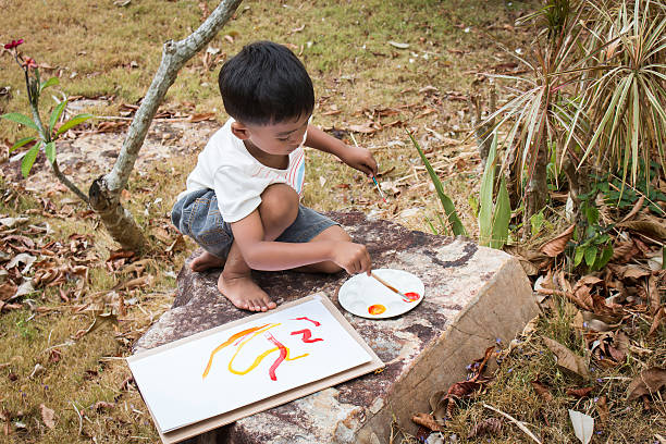 istock little playing panit on white paper in the park 544347888