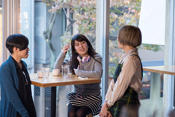 istock Young Japanese ladies talking at the cafe 544348148