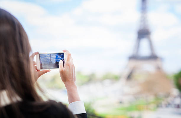 istock Woman Taking a Photo of the Eiffel Tower Using Smartphone 544349216