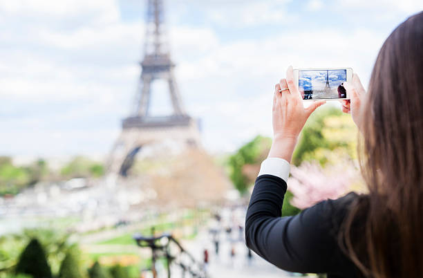 istock Woman Taking a Picture of the Eiffel Tower Using Smartphone 544349268