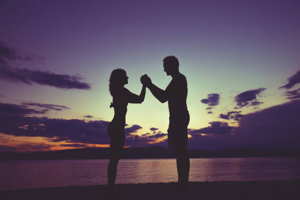 istock Couple enjoying on the beach in sunset / sunrise time. 544349326