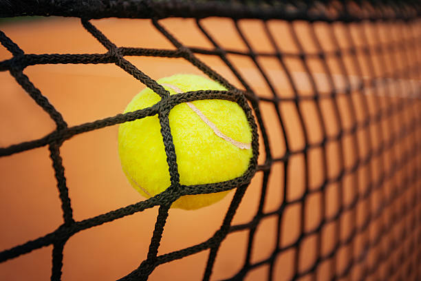 istock Tennis ball hitting the net 544349754