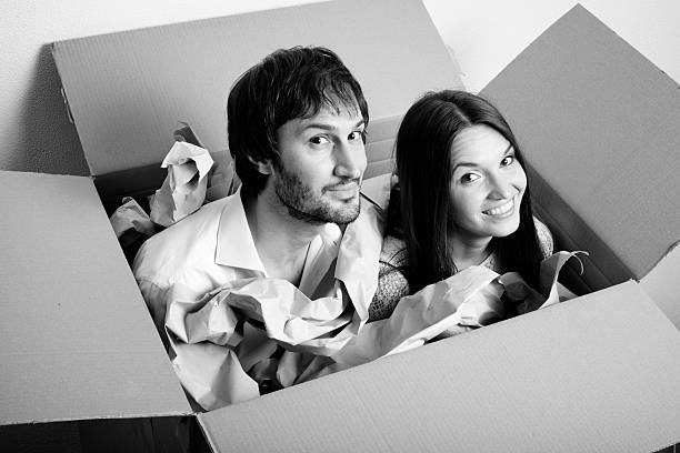 Shipping people in a box - happy young couple
