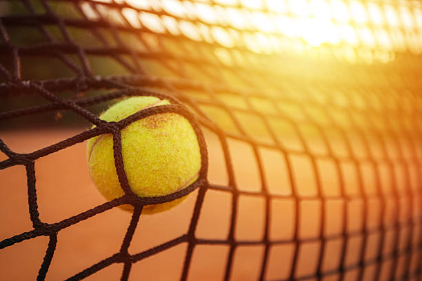 istock Tennis ball in net 544350048