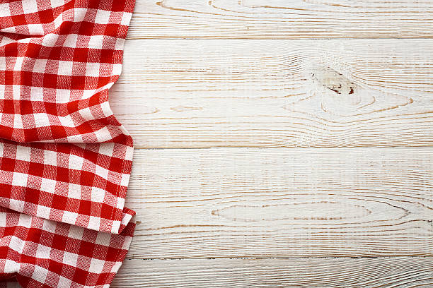 istock Top view of checkered tablecloth on white wooden table. 544351534