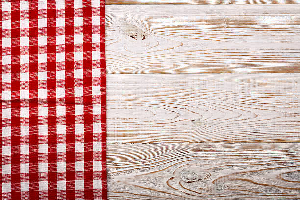 istock Top view of checkered tablecloth on white wooden table. 544351870