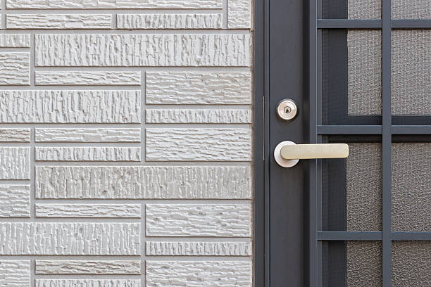 istock Modern door handle with key lock on black door 544352128