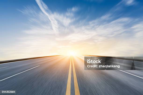 Fuzzy Motion Asphalt Highway Scenery At Sunset Stock Photo - Download Image Now - Road, Blurred Motion, Defocused