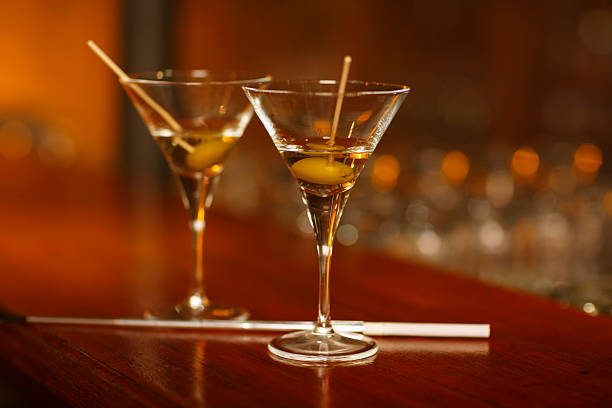 istock Two Martini glass  standing on wooden counter bar   Dry martini 544353064