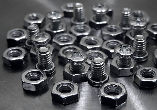 istock Threaded connection. Bolts and nuts on aluminium surface macro shot 544355606