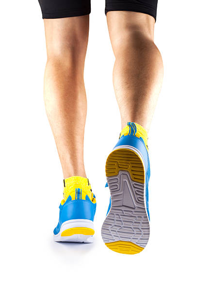 istock Runner legs in sneakers on a white background 544355782