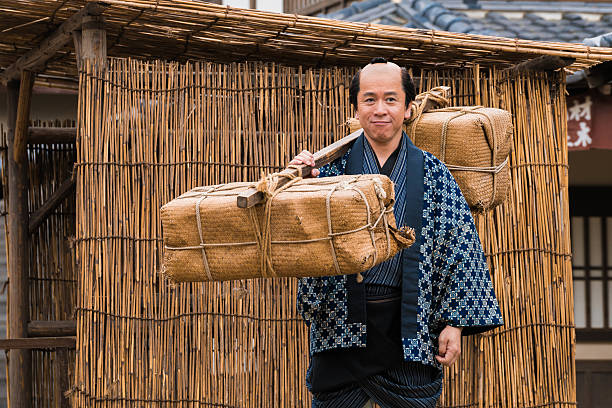 Japanese man dressed in Edo period clothing, carrying packages