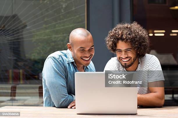 Two Friends Using Laptop Stock Photo - Download Image Now - Friendship, Laptop, Two People
