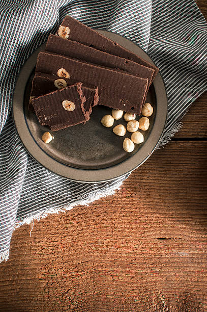 istock Home made chocolate with hazelnuts on a wood table 544357770