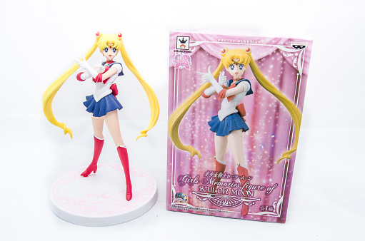 Milan, Italy - June 14, 2016: Closeup on a Sailor Moon Action Figure and its box isolated on white.