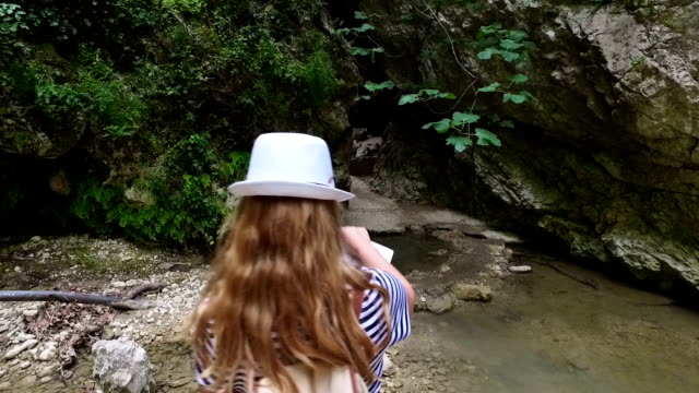Female hiker looking at waterfall