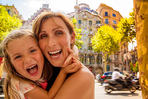 family barcelona gaudi house mother with daughter visiting barcelona rambla with gaudi house background la rambla stock pictures, royalty-free photos & images