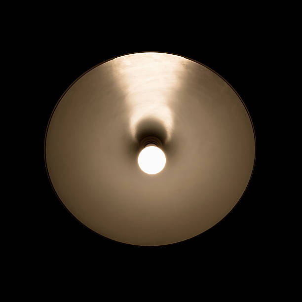 istock Tungsten lamp glowing in the round lampshade 544443412