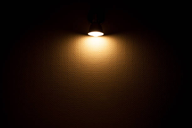 Wall lamp illuminated white wall with textured wallpaper, spotlight background