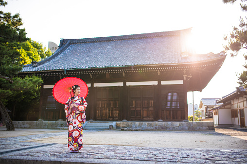 Young woman posing in a kimono in front of a Hyakumanben Chionji temple. Kyoto, Japan