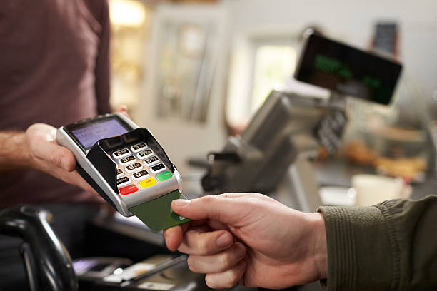 istock Customer makes credit card payment over counter at a cafe 544446530